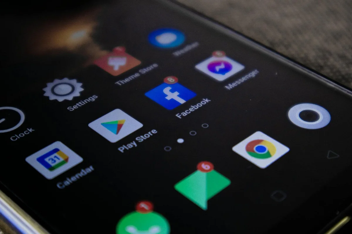 Detailed view of a smartphone screen with popular app icons including Facebook a