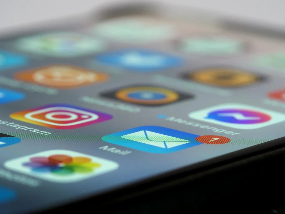 Detailed close-up of smartphone screen displaying various app icons and notifica